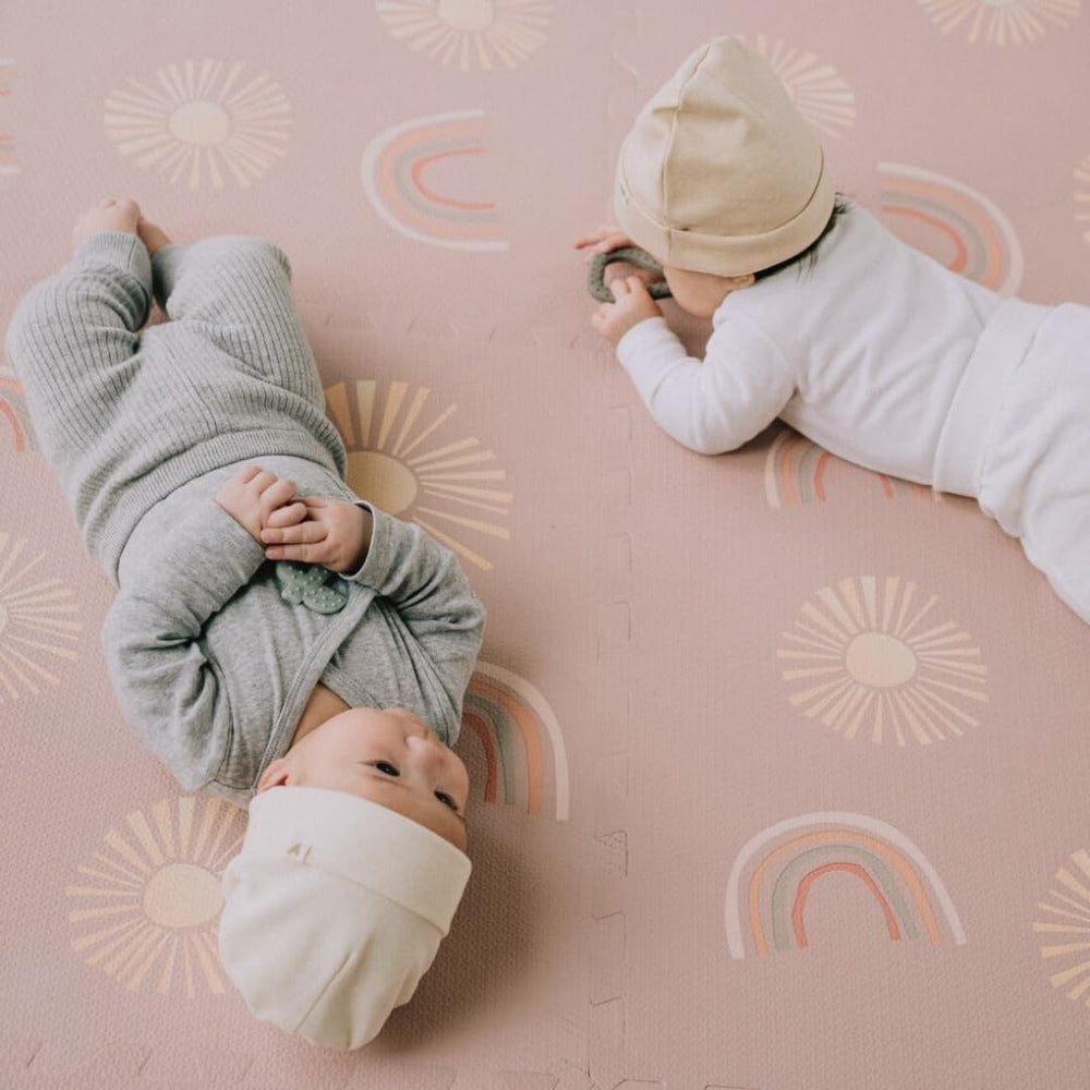 Simple Kid Co. Play Mat dusty rose Sunset Rainbows design adds stylish, kid-friendly decor.