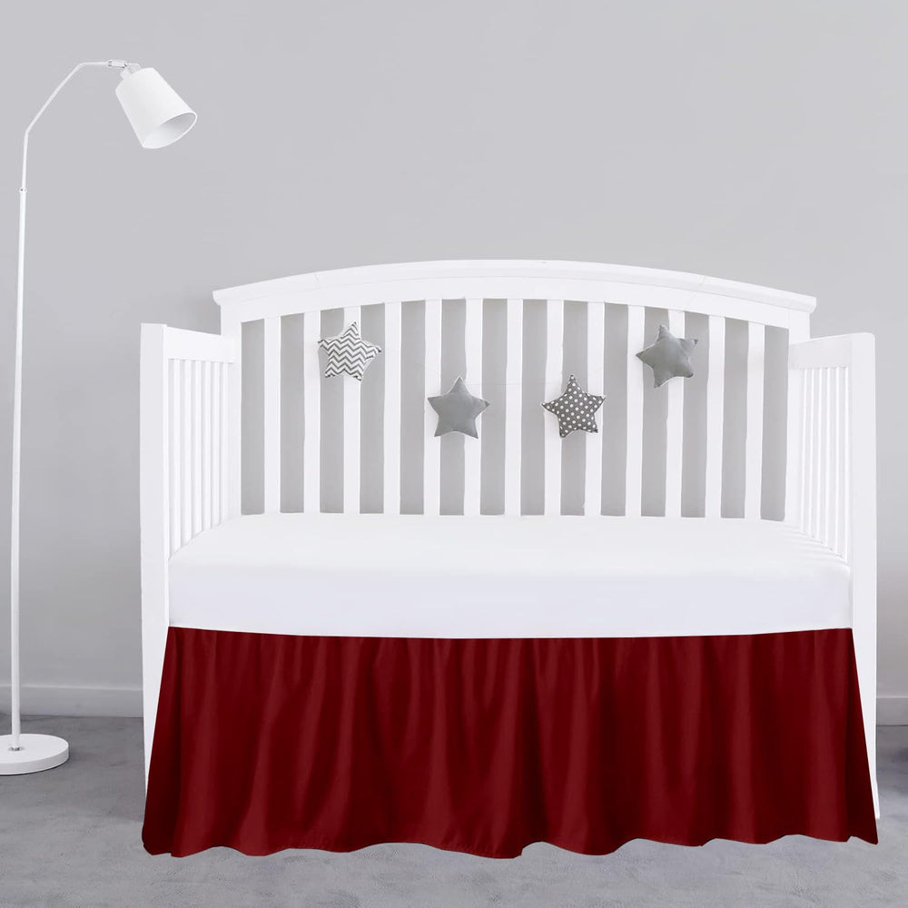 Sky Beddings burgundy crib skirt front view highlighting tailored fit and rich color.