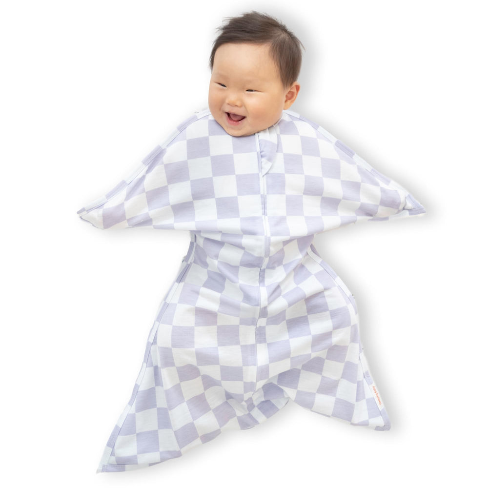 SleepingBaby Zipadee-Zip lavender-check swaddle on crib promotes restful sleep