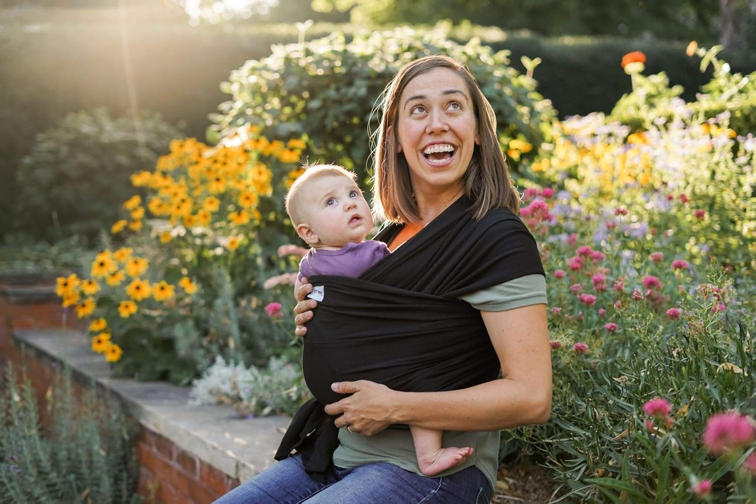 Sleepy Wrap chest carry with newborn close to caregiver's heart for bonding.