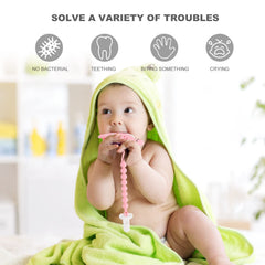 Slotic dinosaur teether in hand highlights ergonomic, non-slip grip for tiny fingers.