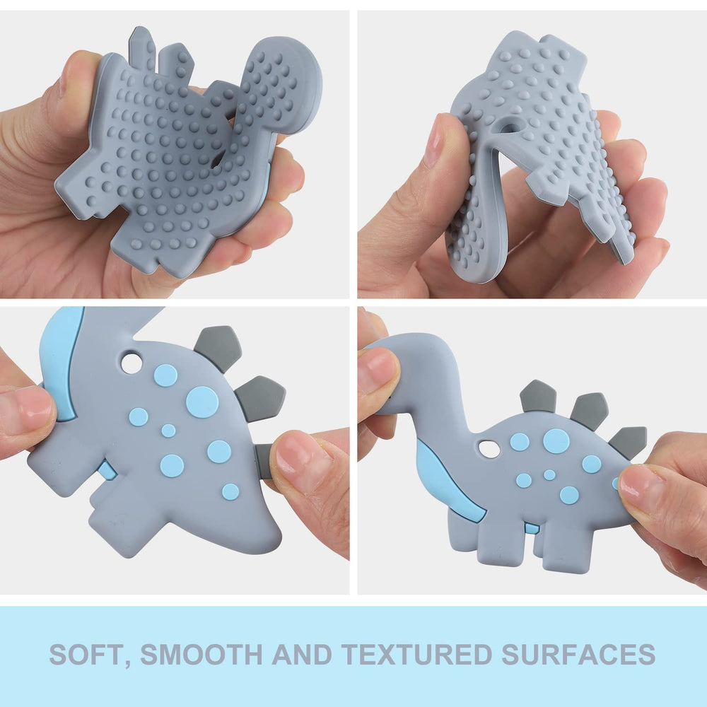Slotic grey dinosaur teether held by a baby hand for easy grip