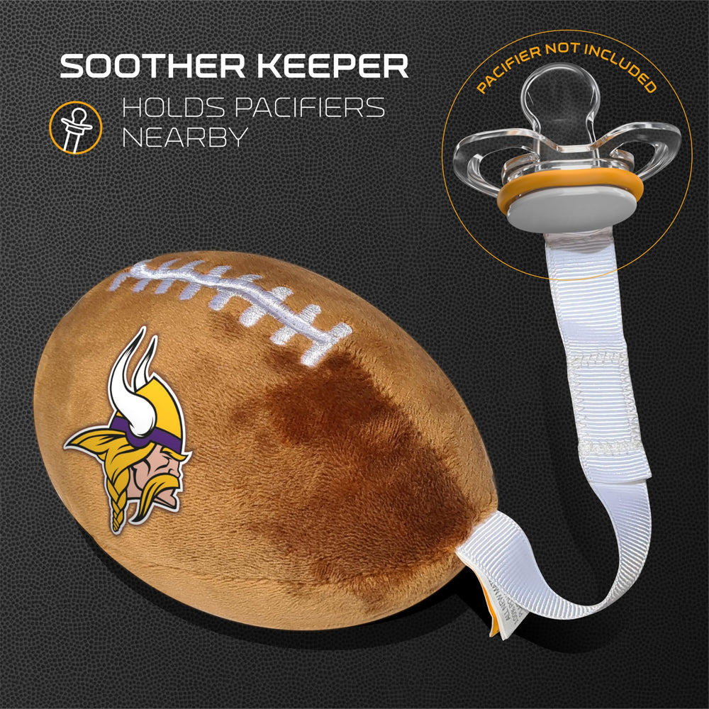 Baby holding Smilo plush football pacifier holder during playtime for comfort.