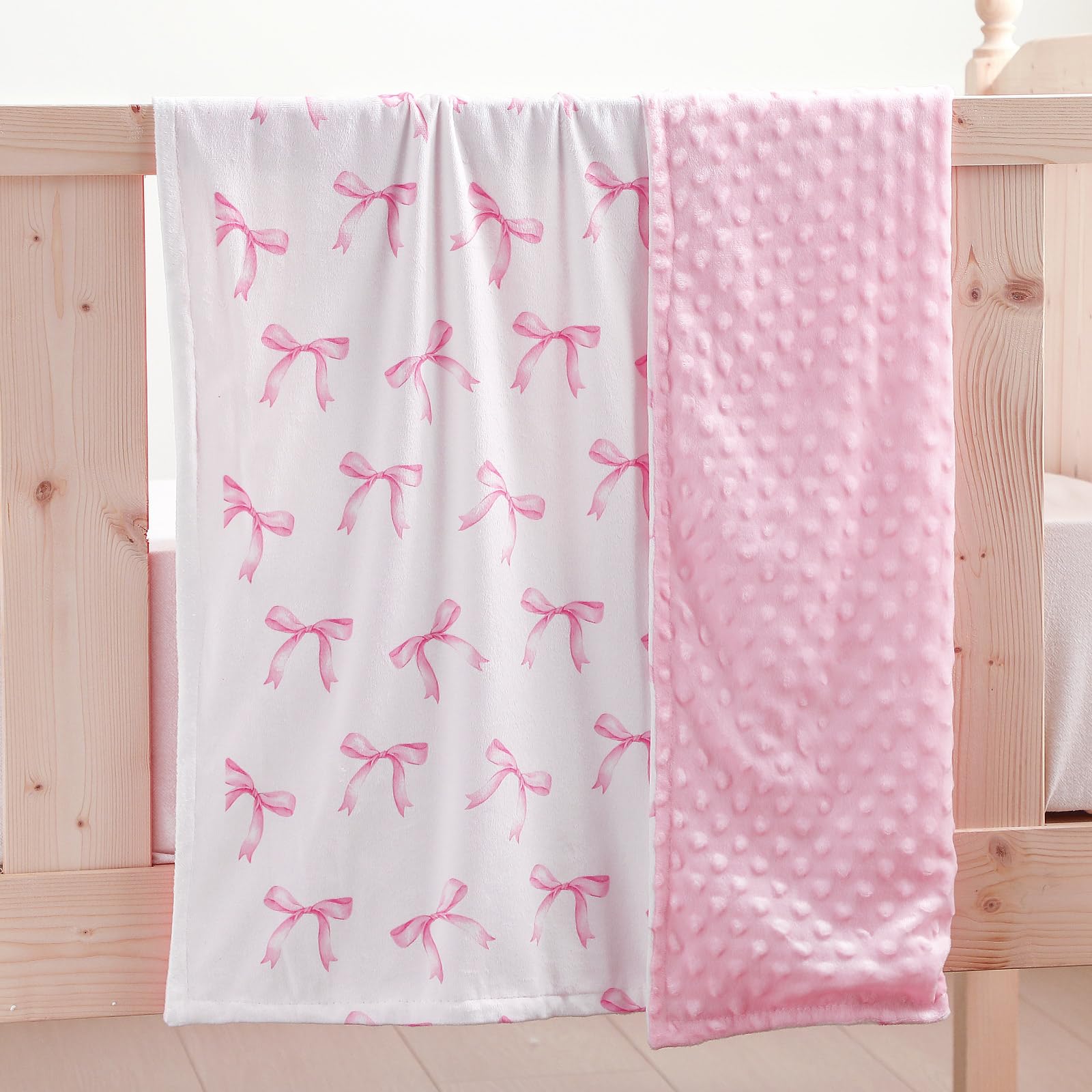 SmoothNovelty pink bow blanket pairs with nursery decor for preppy style.