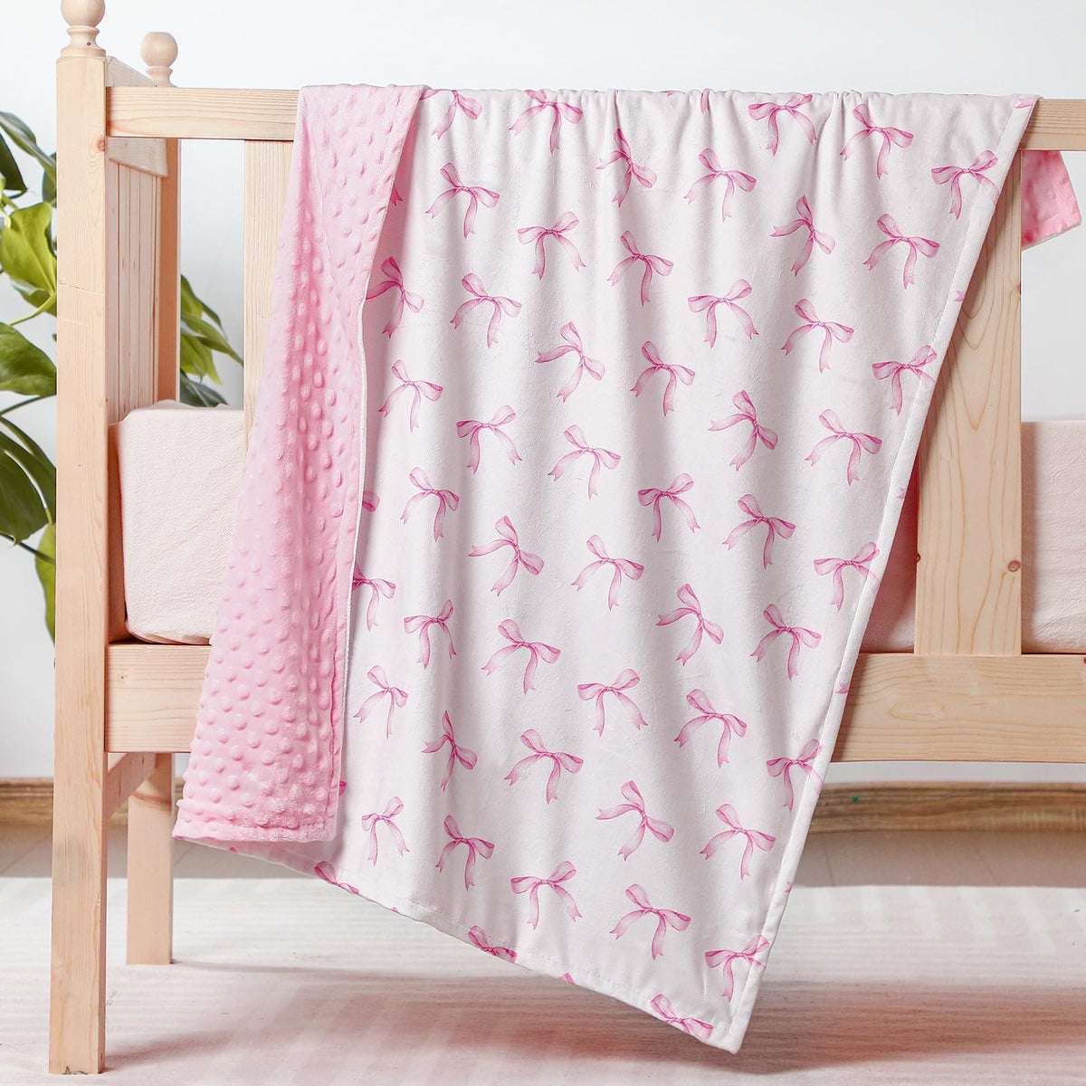 SmoothNovelty pink bow blanket: plush swaddle comfort for baby girls.