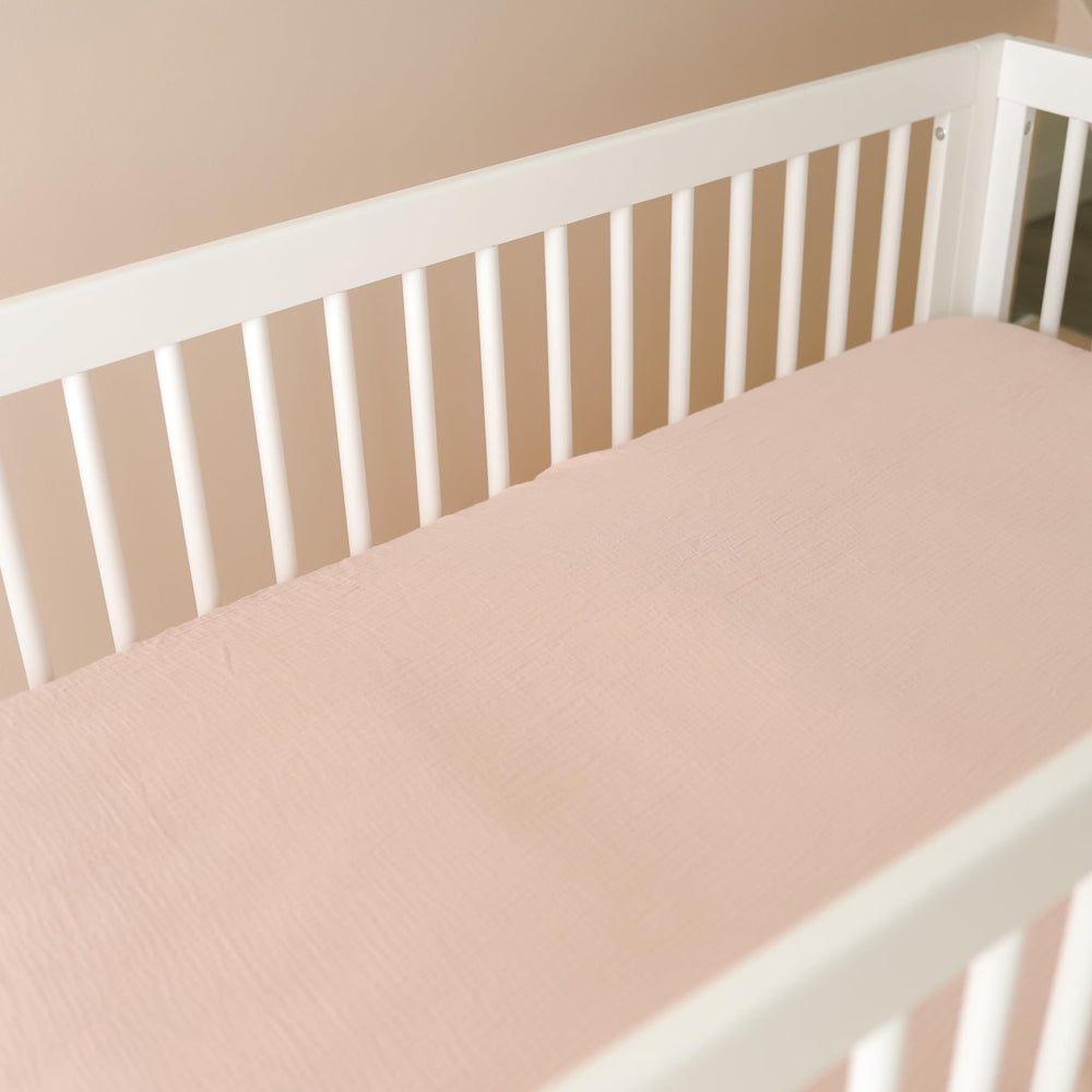 Snuggle Me crib sheets in a serene nursery flatlay for minimal decor