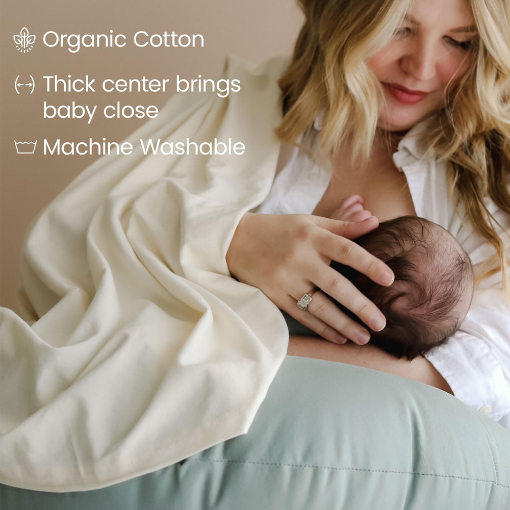 Snuggle Me pillow in bottle-feeding pose offers comfortable nursing sessions.