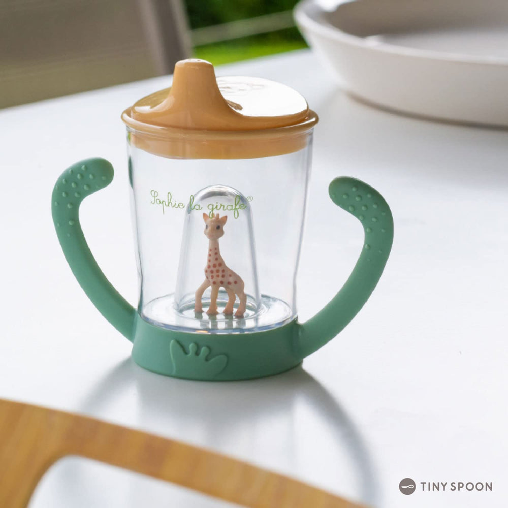 Sophie la girafe anti-leak cup valve system keeps drinks contained for mess-free sips.