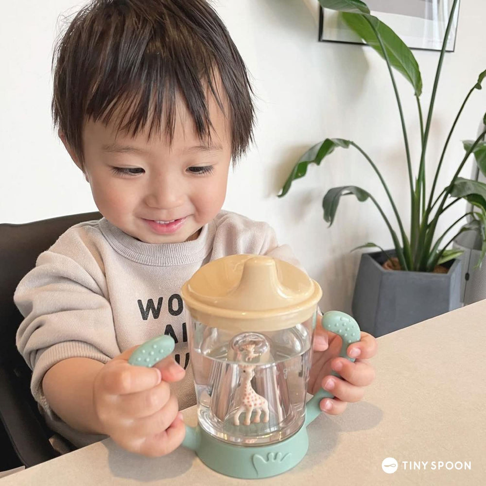 Sophie la girafe mascot transition cup promotes confident bottle-to-cup switches.