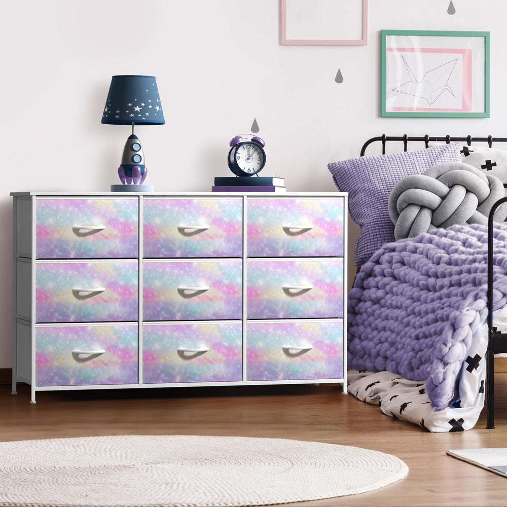 Sorbus Kids Dresser wood-top display area styled with lamp and books.