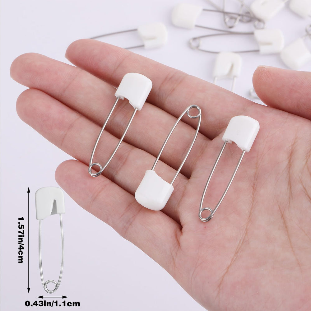 Sorcristy safety pins on quilt fabric illustrate multi-layer holding for sewing projects