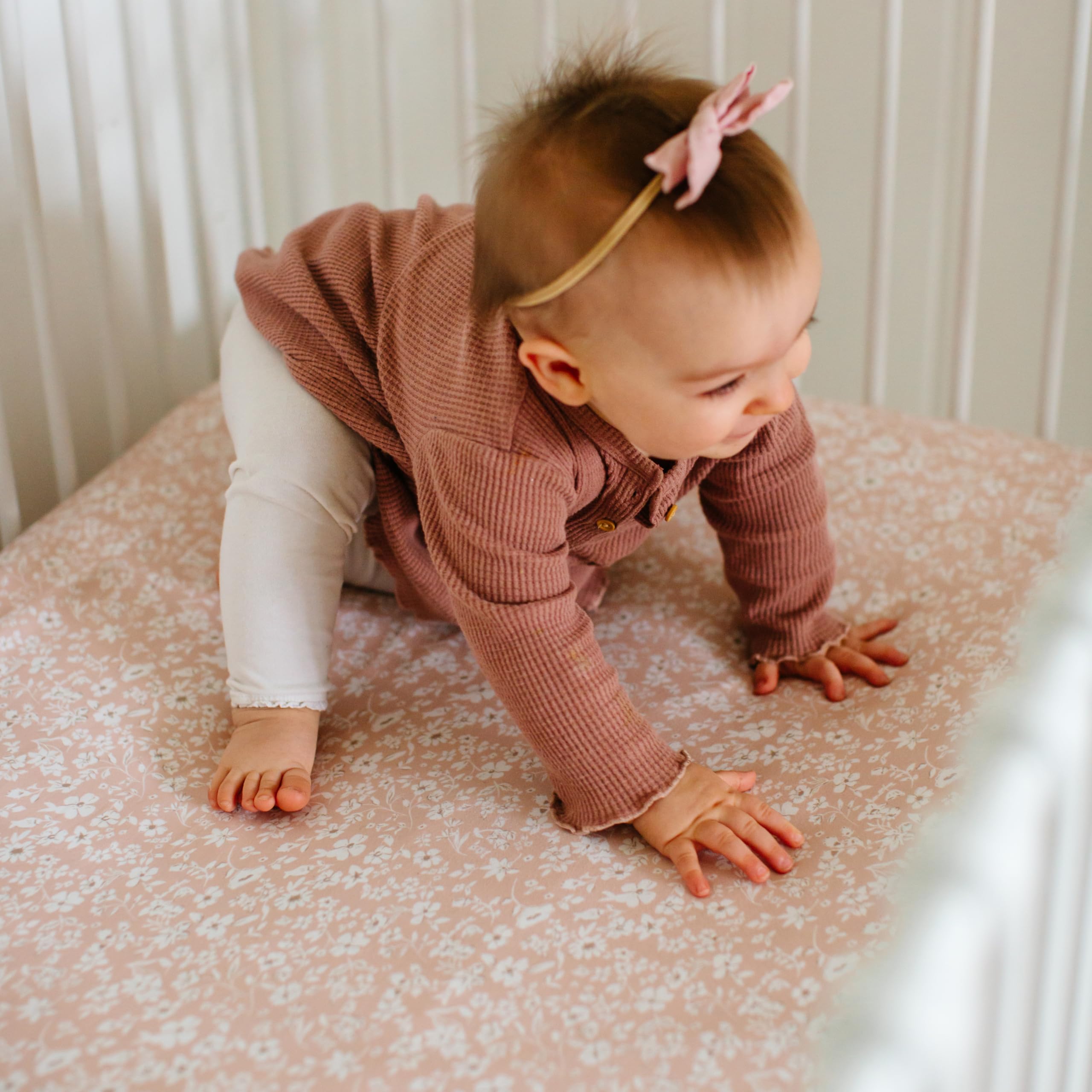 Sorrel + Fern crib sheets fade-resistant fabric on nursery bed.