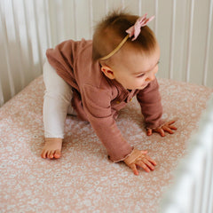 Sorrel + Fern crib sheets fade-resistant fabric on nursery bed.