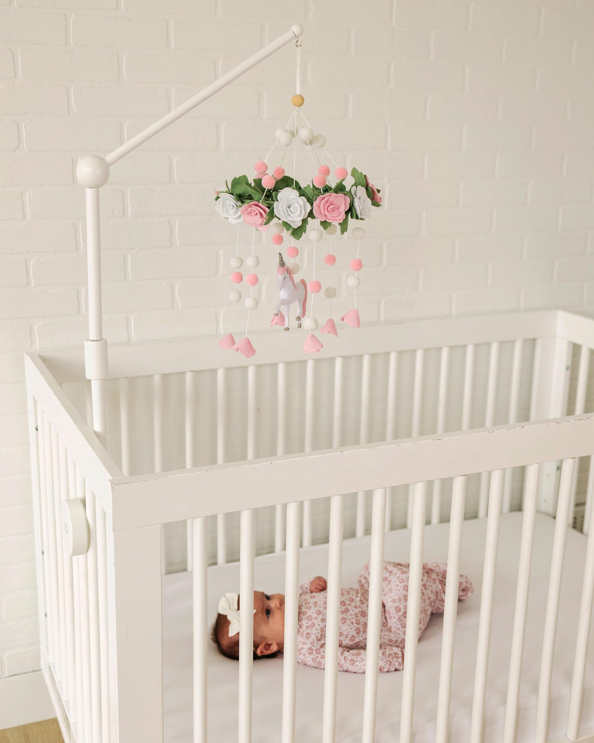Sorrel + Fern Unicorn Blossom mobile in neutral tones enhances serene baby room aesthetics.