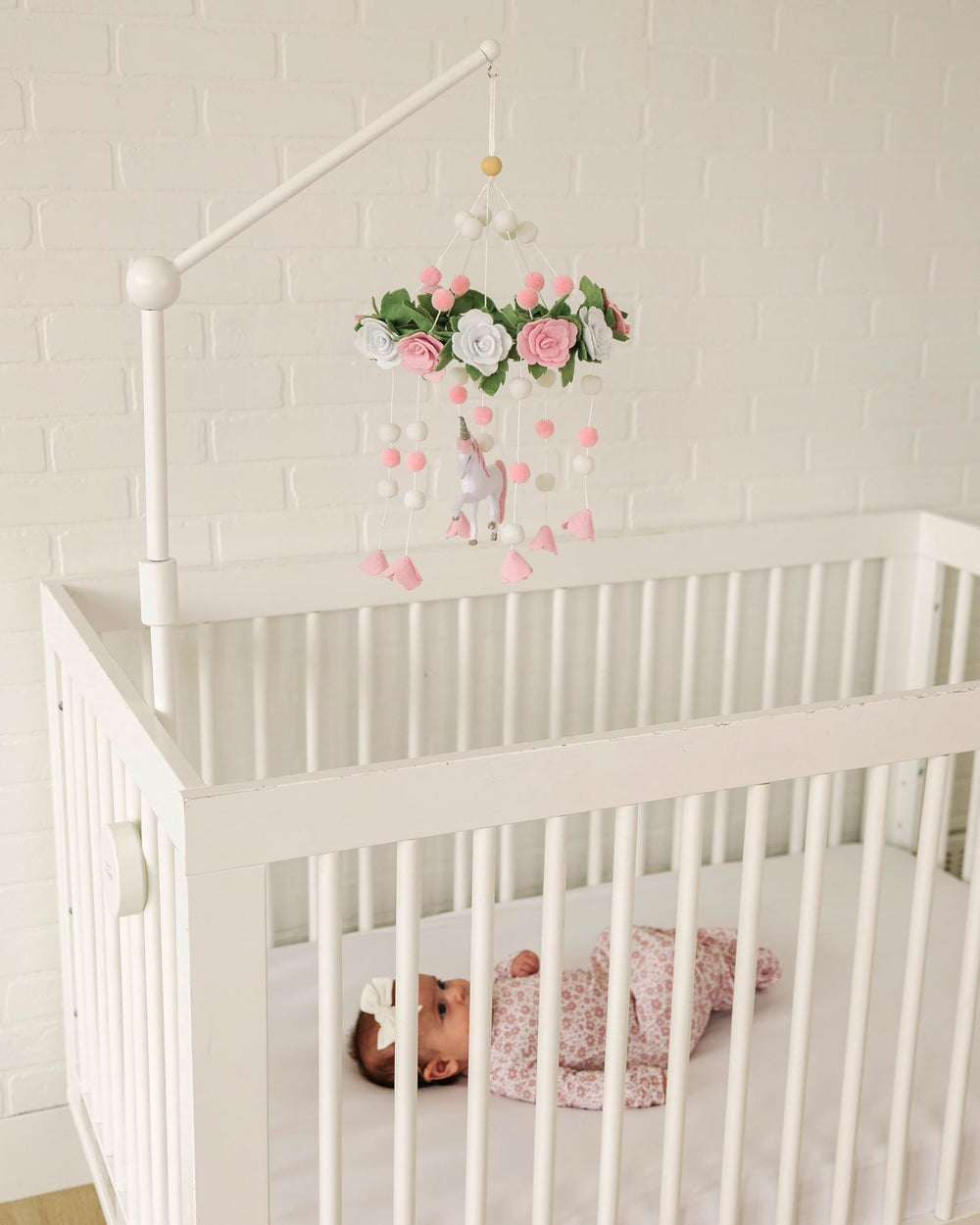 Sorrel + Fern Unicorn Blossom mobile in neutral tones enhances serene baby room aesthetics.