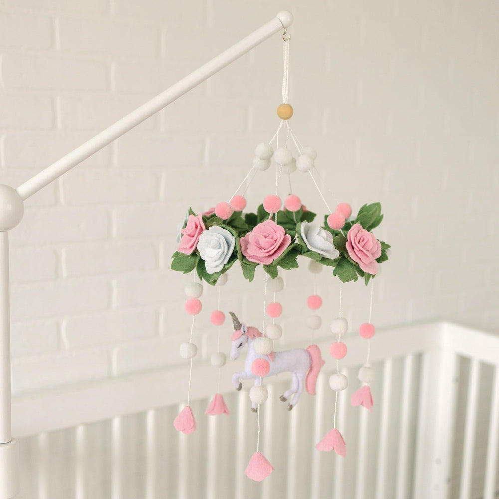 Sorrel + Fern Unicorn Blossom mobile featuring pink pom-poms for playful texture in the nursery.