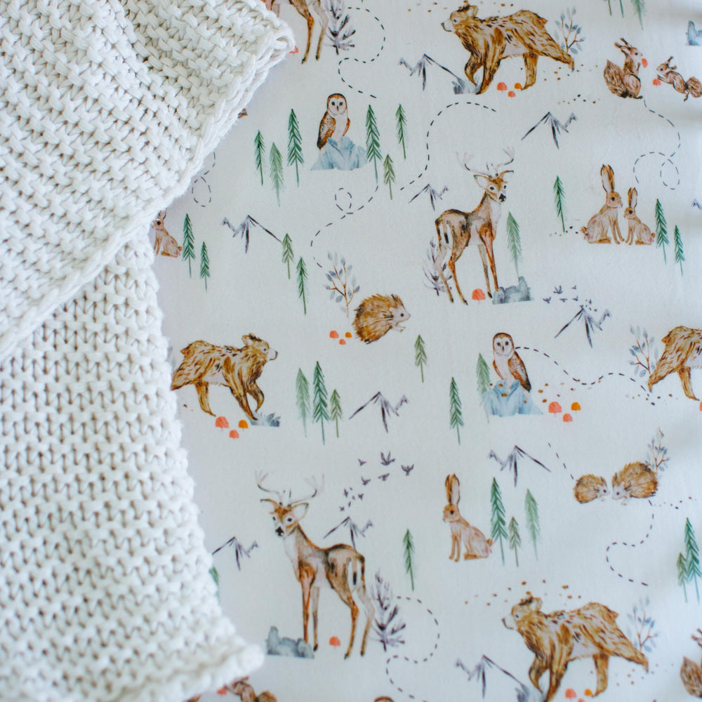 Sorrel + Fern Magic Forest nursery bedding closeup reflects calming design.