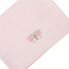 Spasilk pink blanket draped on lap for easy-care, machine-washable comfort