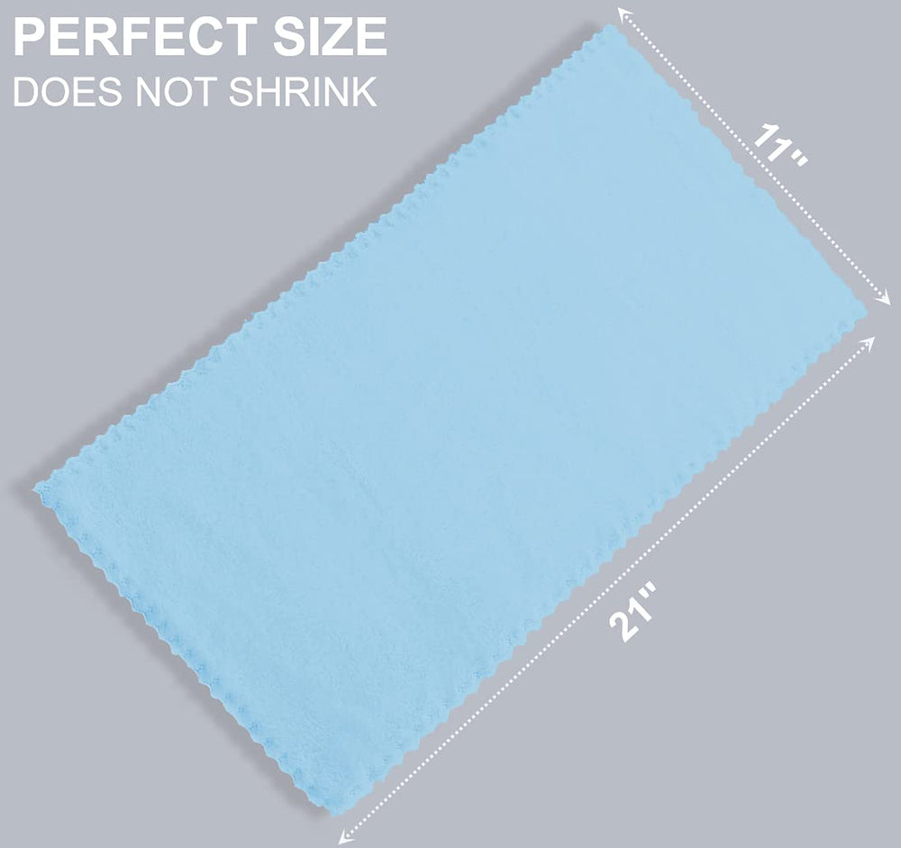 Spotted Play Aquamarine burp cloths used during a baby outfit change.