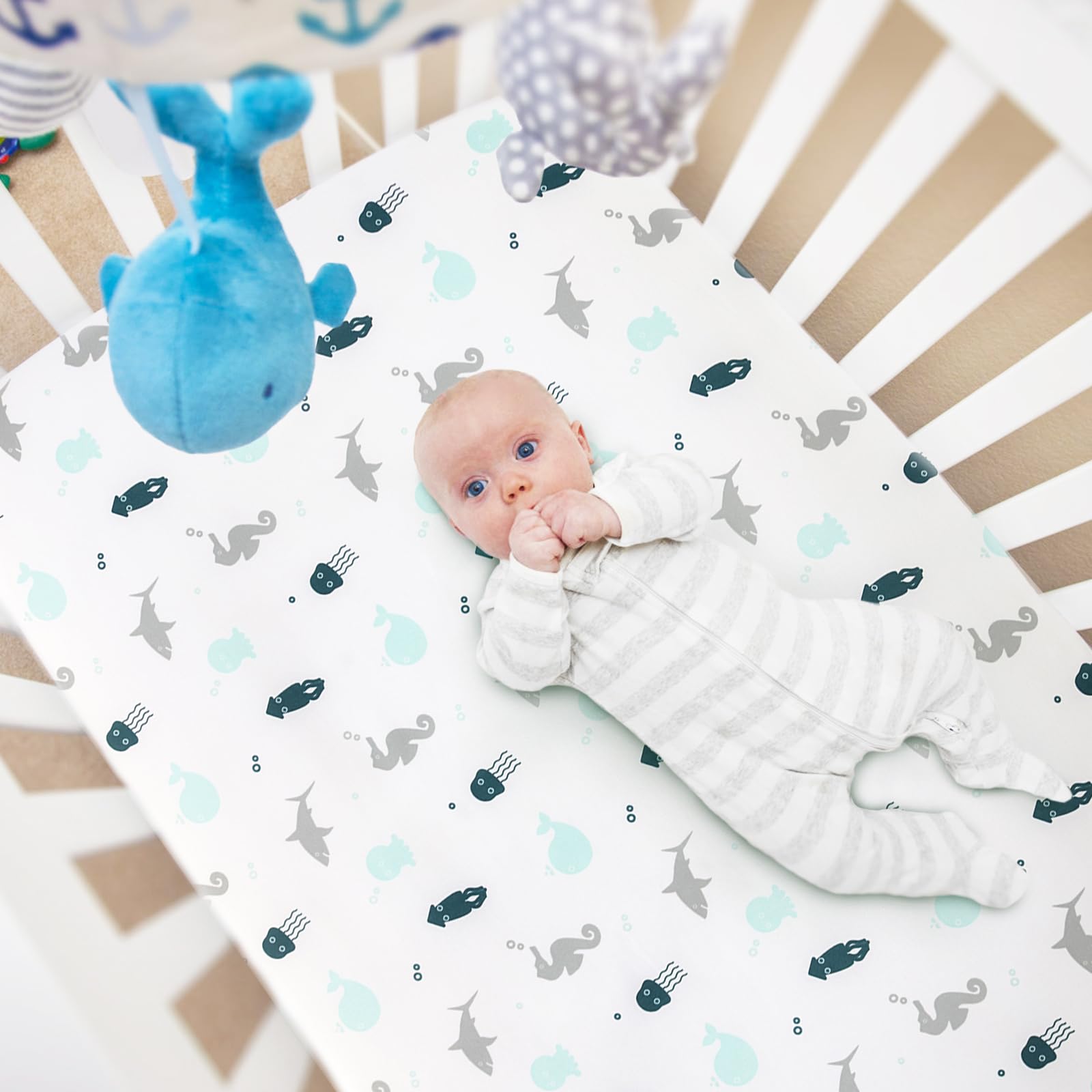 SPRINGSPIRIT mini crib sheets close-up on SnugFit elastic band for secure fit.