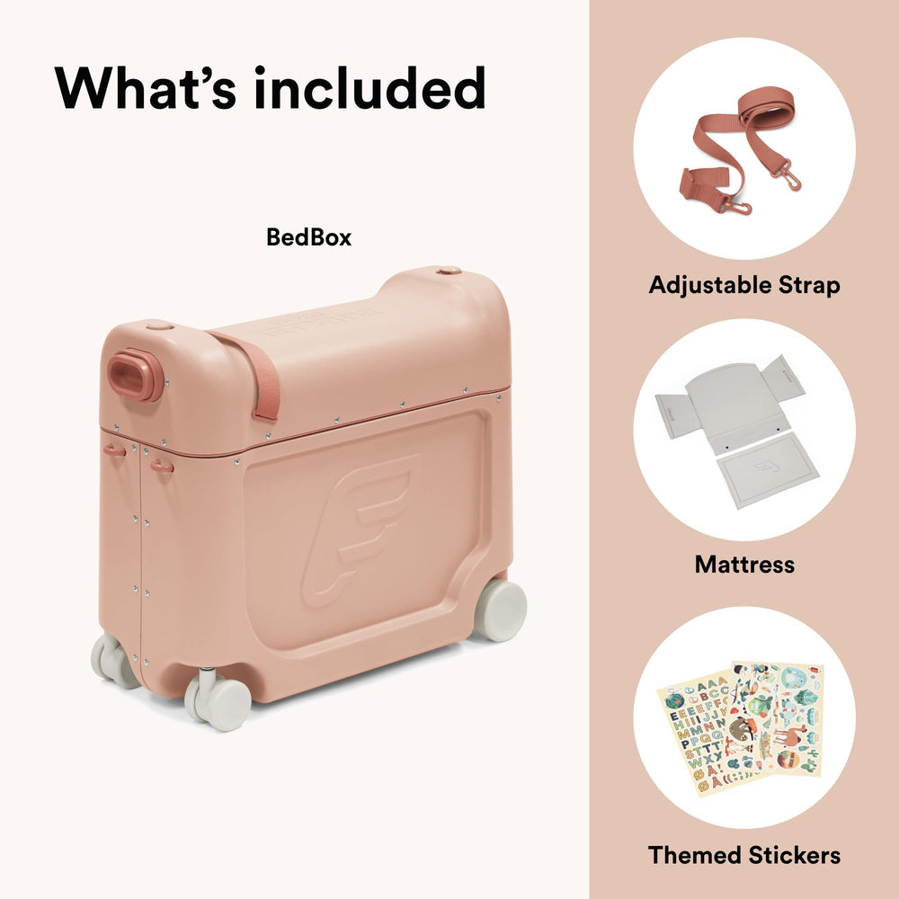 Stokke JetKids BedBox coral pink in-use on airplane—cozy rest space during flights