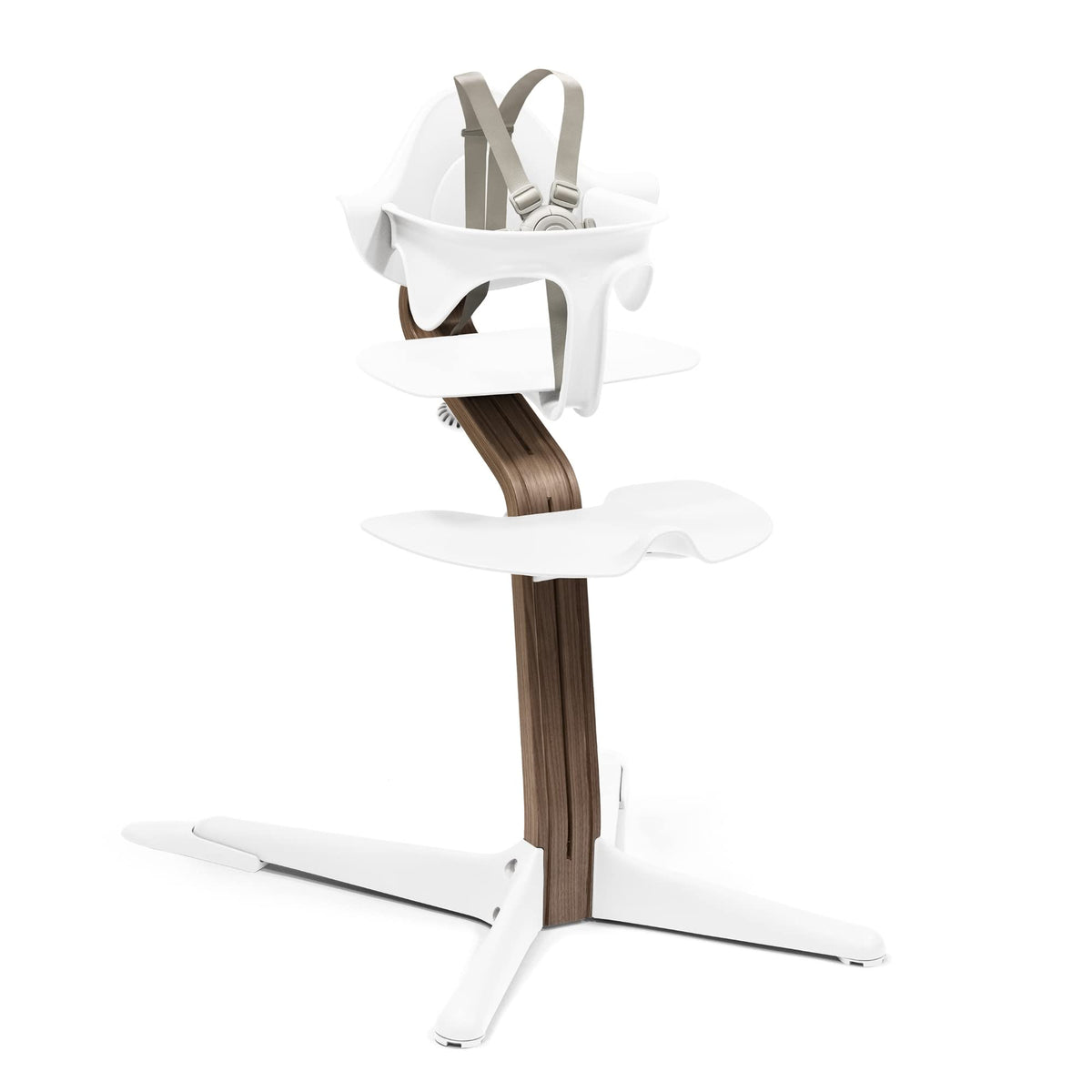 Stokke Nomi high chair beside family table, seamless tool-free height adjustability.