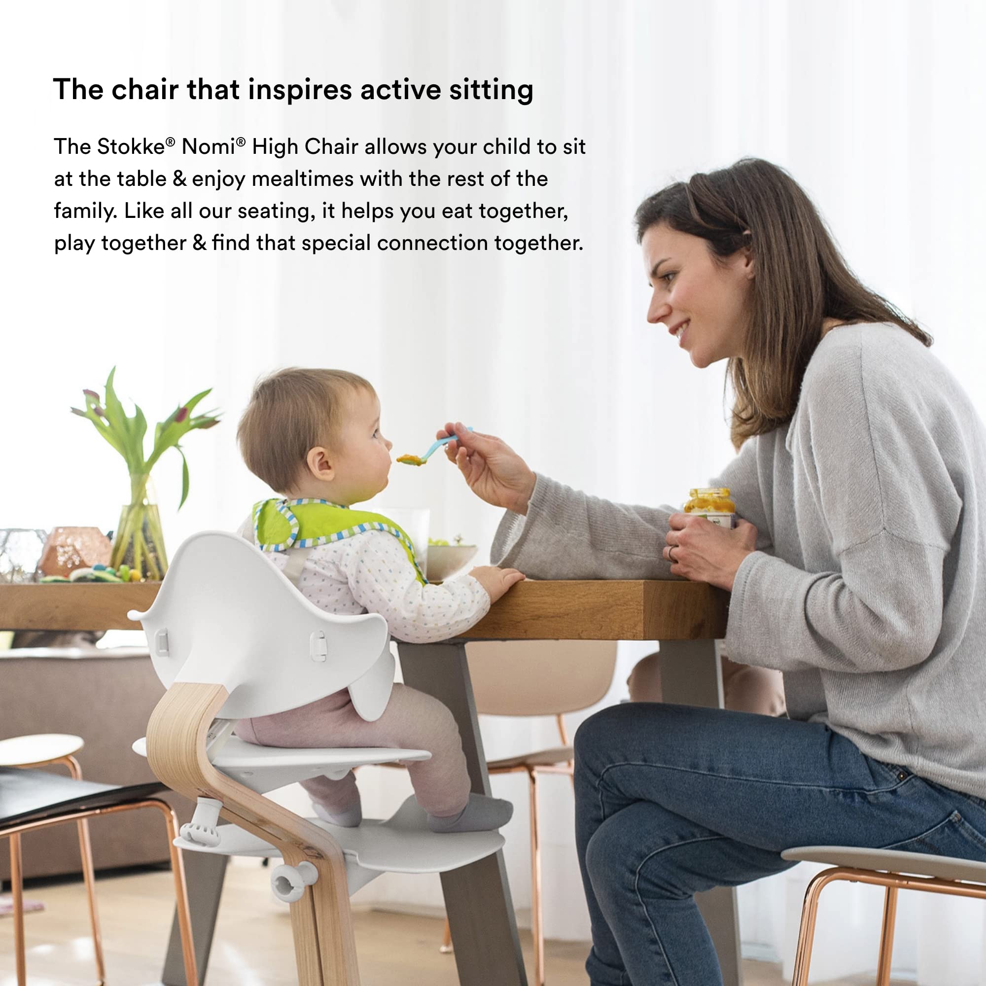 Stokke Nomi walnut stem design adds natural warmth and durability.
