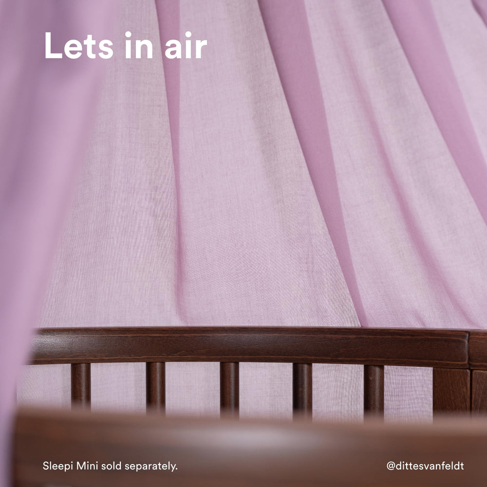 Stokke Sleepi Canopy V3 Lavender pleated detailing adds Scandinavian style to nursery decor.