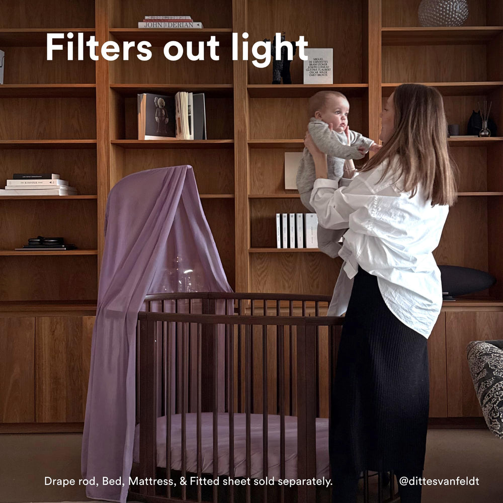 Stokke Sleepi Canopy V3 Lavender soft-light drape creates a gentle sleep environment.