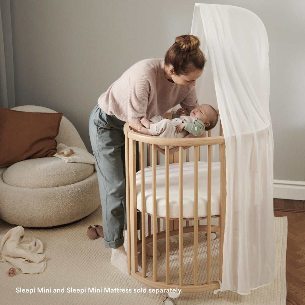 Stokke Sleepi Canopy V3 white mobile-attachment supports calming nest atmosphere.