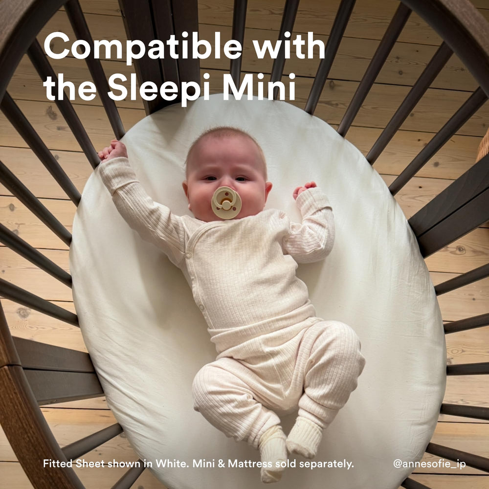Stokke Sleepi Mini Fitted Sheet V3 on Sleepi mattress highlights secure zippered fit for safe sleep.