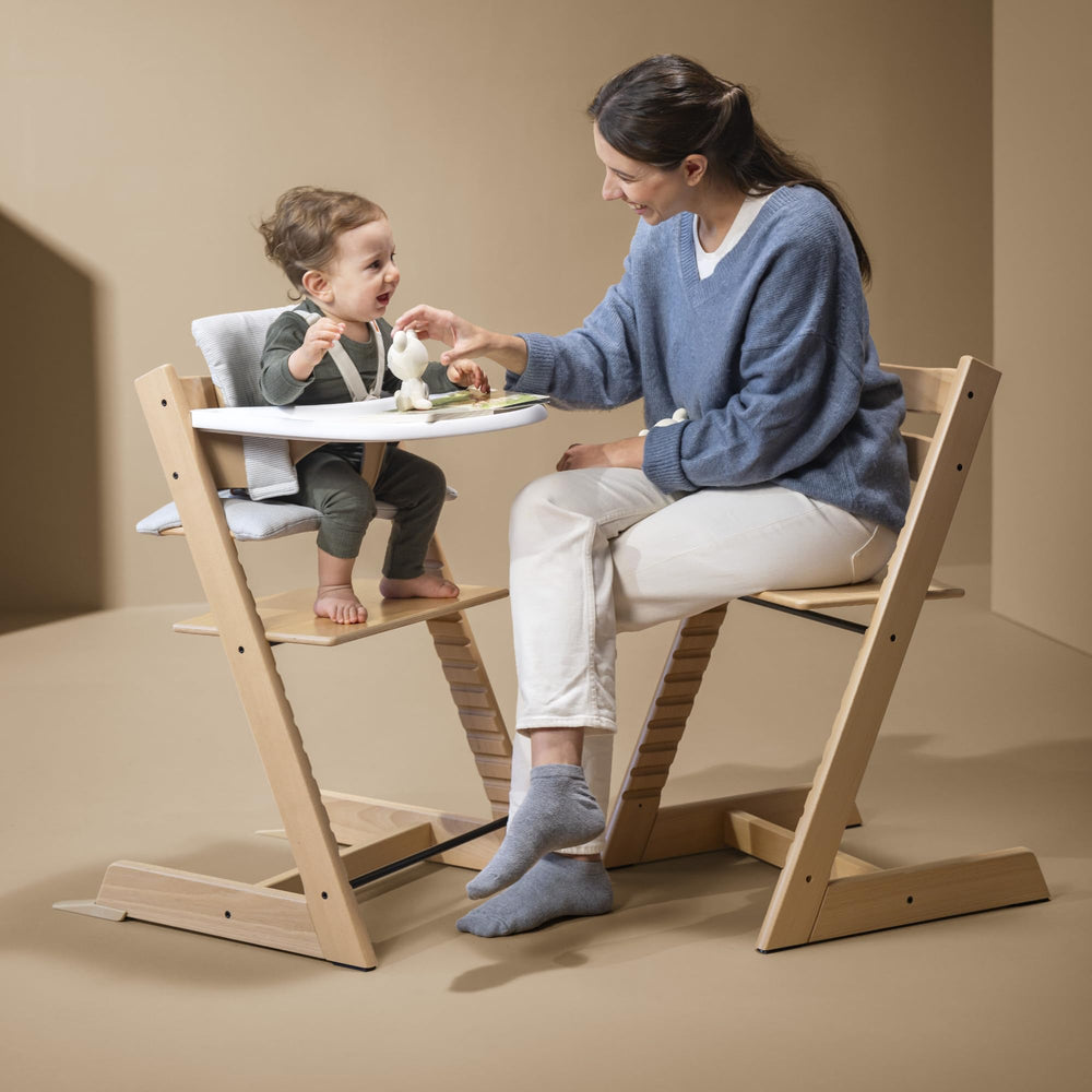 Stokke Tripp Trapp adjustable seat aligns with child's height for comfort.