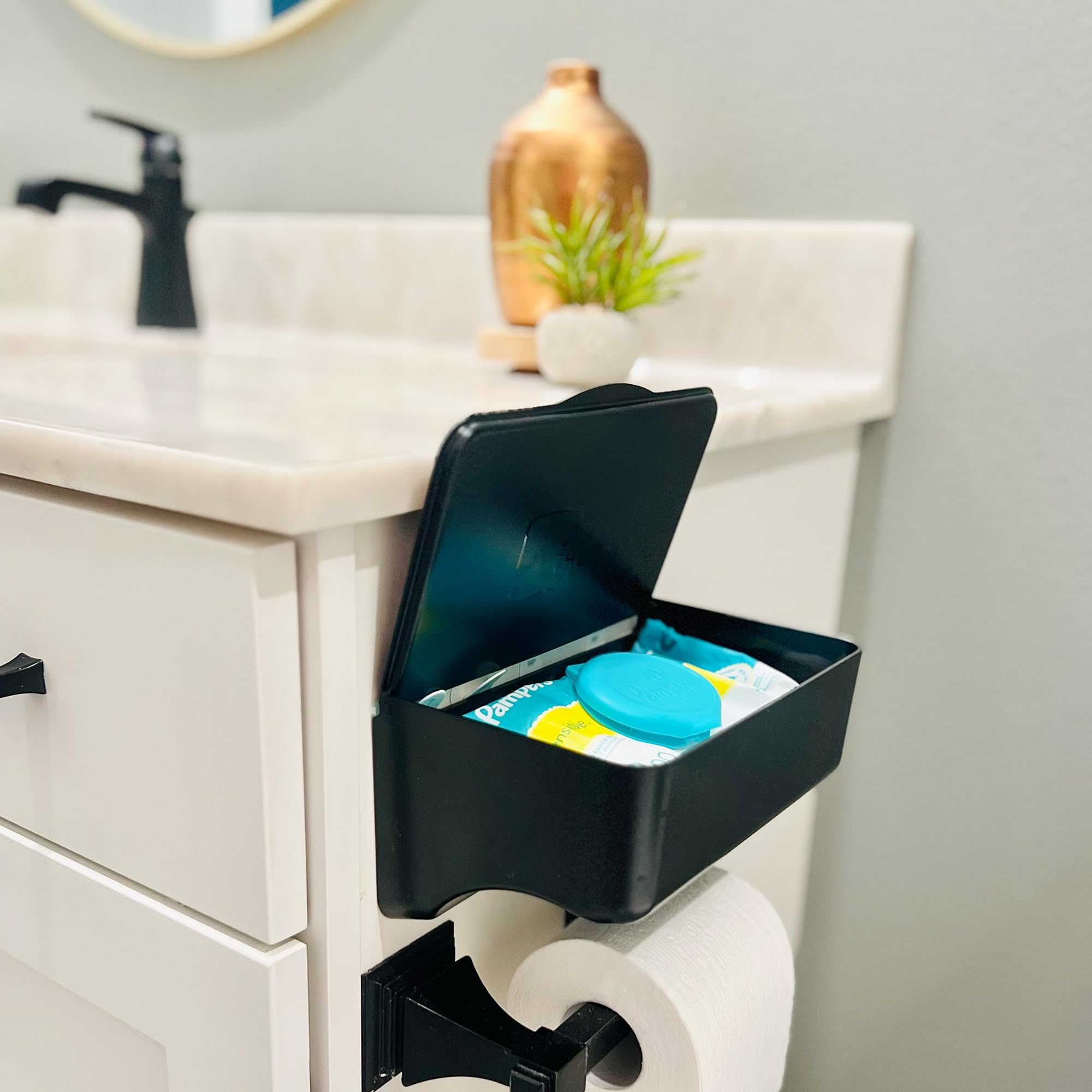 Storage Theory wipe holder black adhesive installation shows quick, damage-free wall mounting.