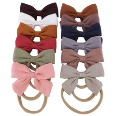 Sugarmelon linen bow headband on newborn with skin-friendly soft fabric.