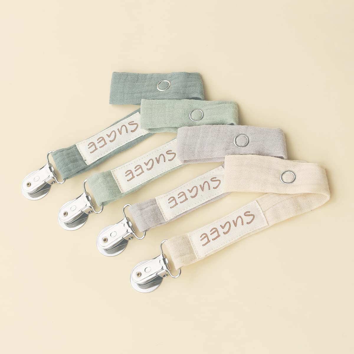 Sugee baby pacifier clip beige close-up showing soft fabric for comfy wear.