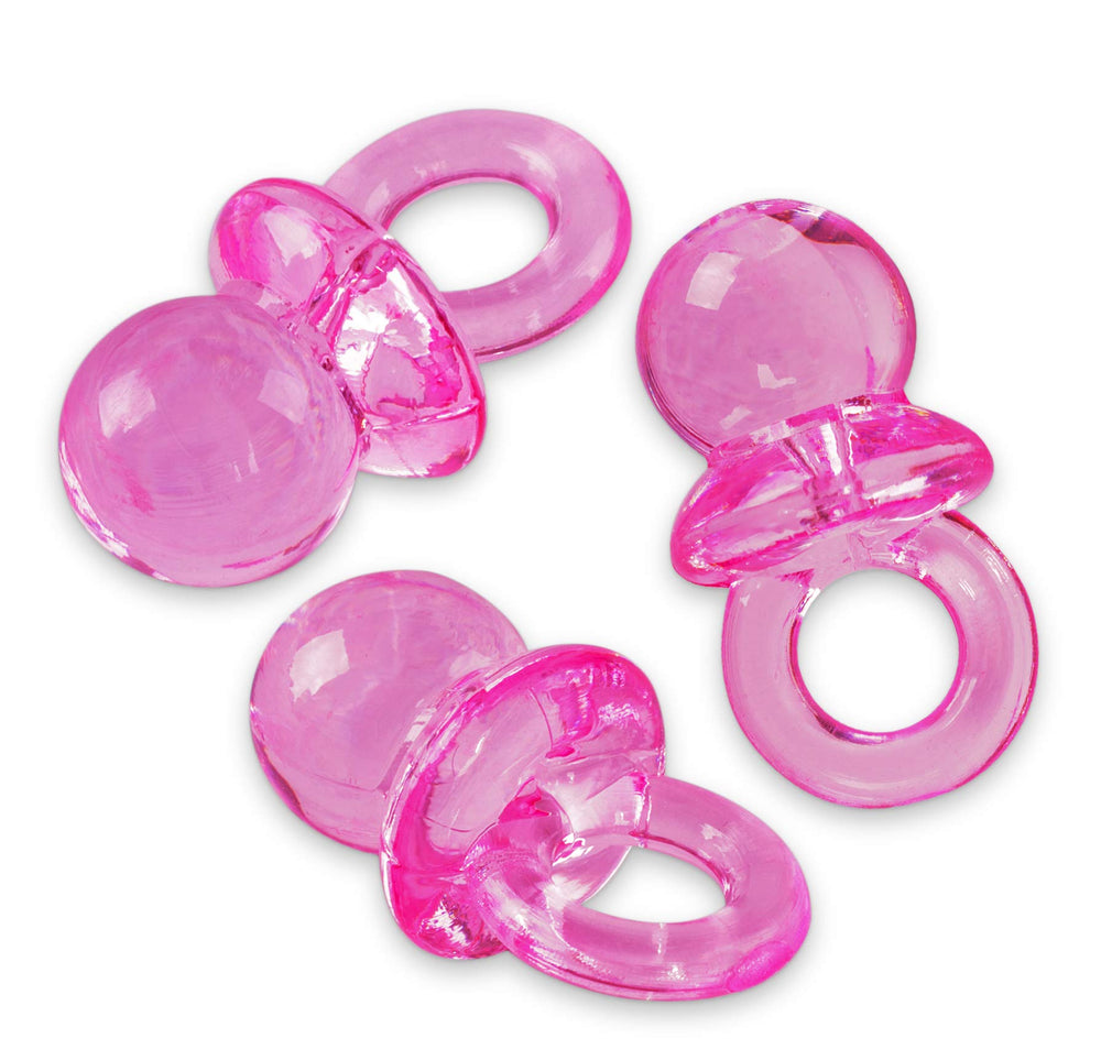 Super Z Outlet pink mini pacifiers used as playful cake toppers at celebrations.