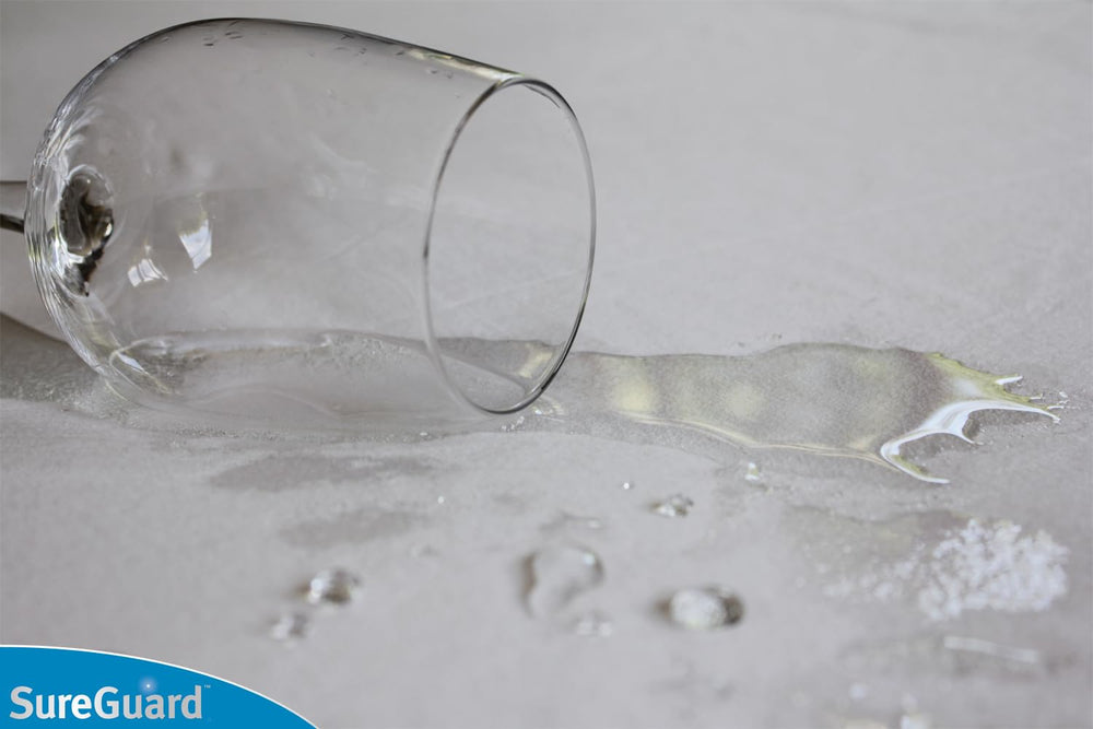 SureGuard protector close-up reveals waterproof layer and soft cotton surface.