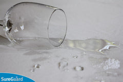 SureGuard protector close-up reveals waterproof layer and soft cotton surface.
