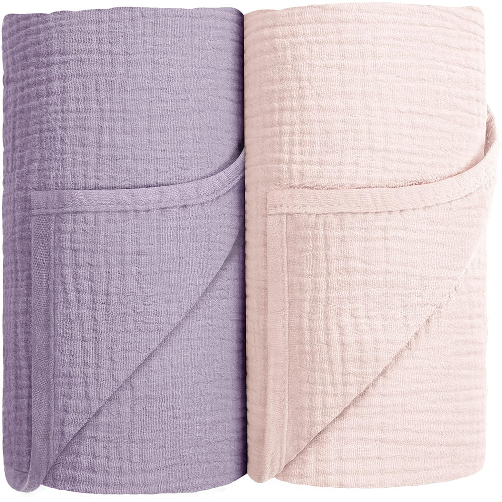Susurration muslin swaddle blanket pink-purple folded for gentle newborn comfort and breathable wrapping.