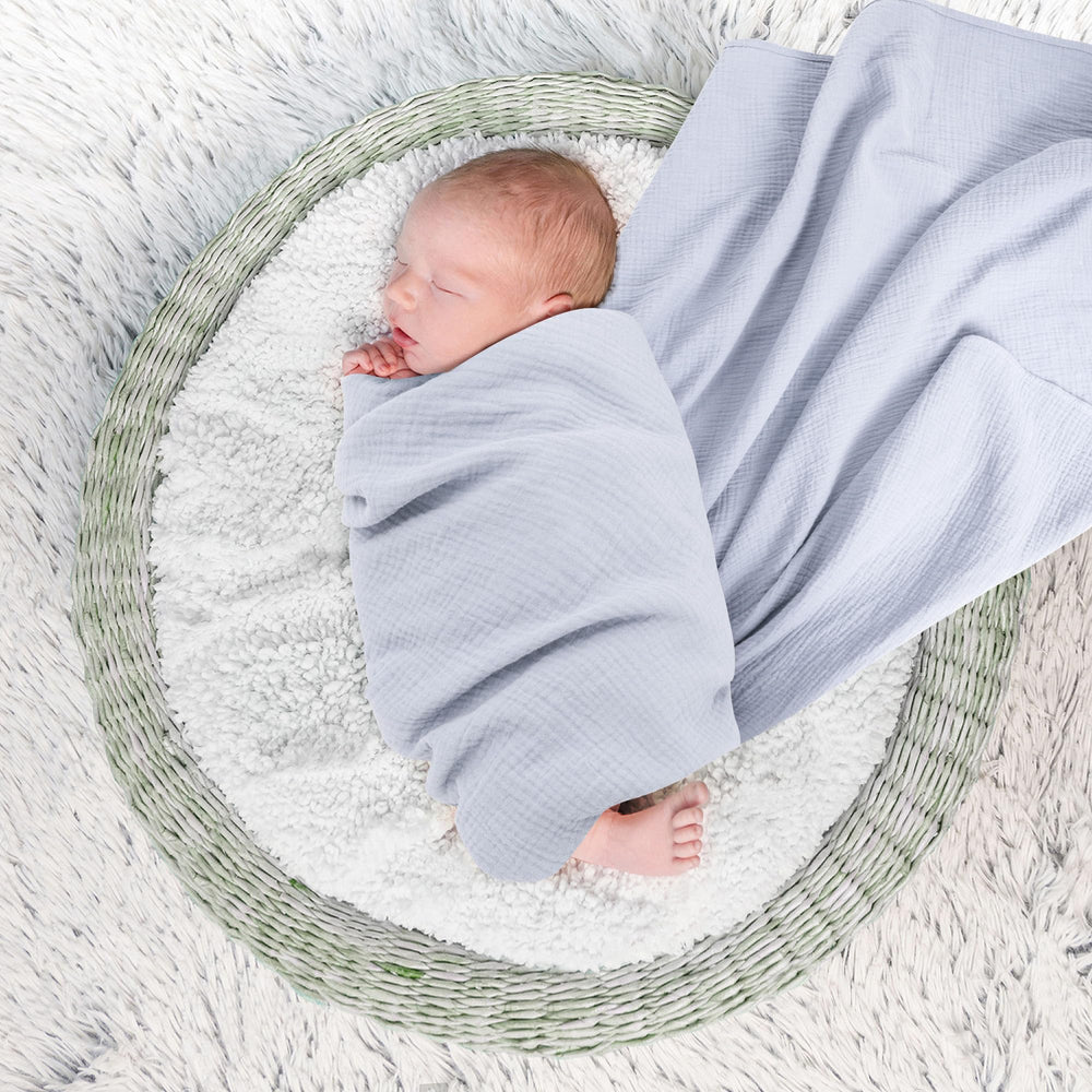 Susurration muslin swaddle blanket navy closeup shows skin-friendly fabric for delicate newborn skin.