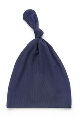 SUZEL knotted hat navy adds soft warmth to chilly days.
