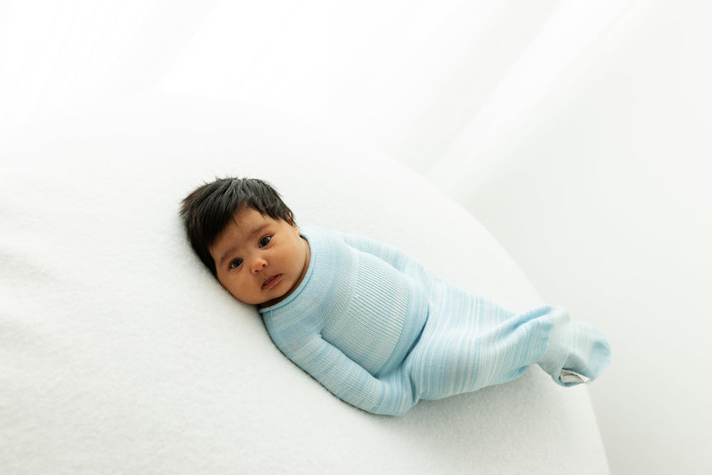 Swaddelini Swaddle Sleep Sack Blue in-use image depicts snug fit for baby relaxation.