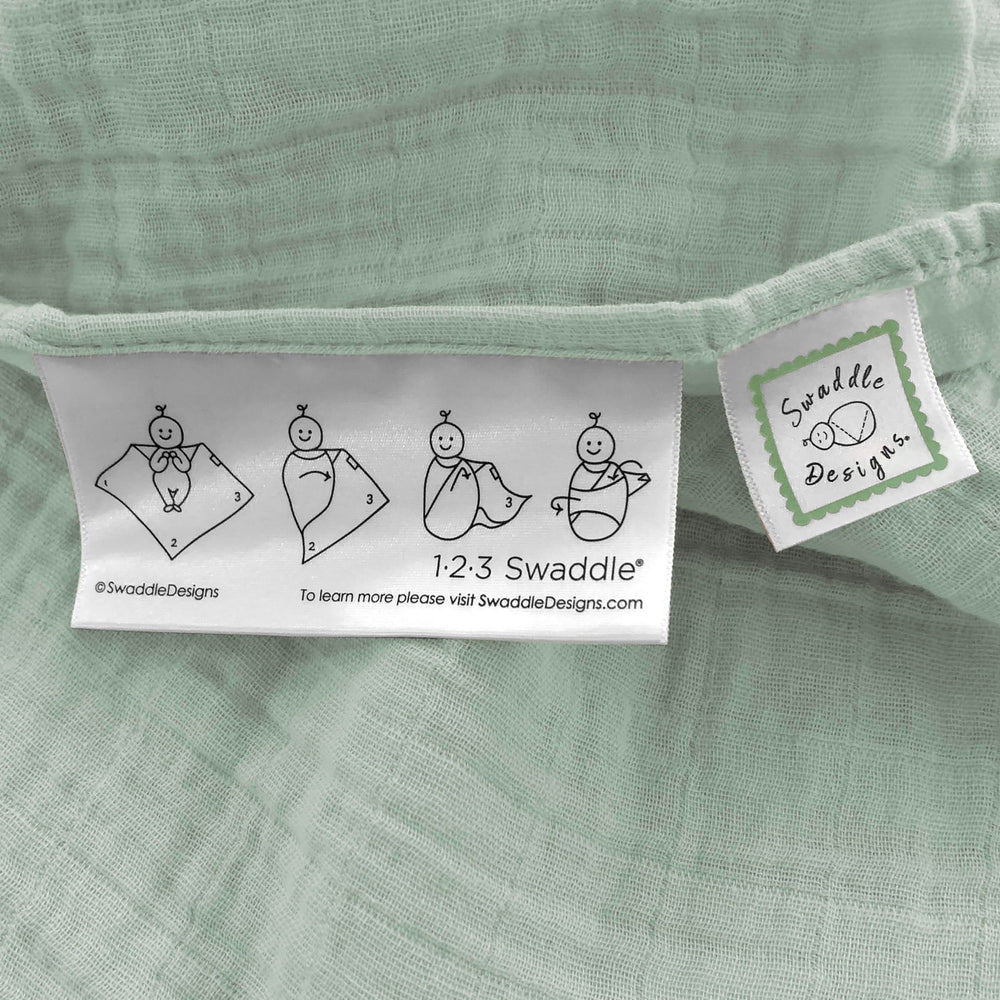 SwaddleDesigns Jadeite baby swaddled for snug comfort
