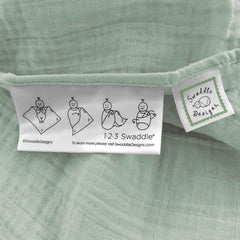 SwaddleDesigns Jadeite baby swaddled for snug comfort