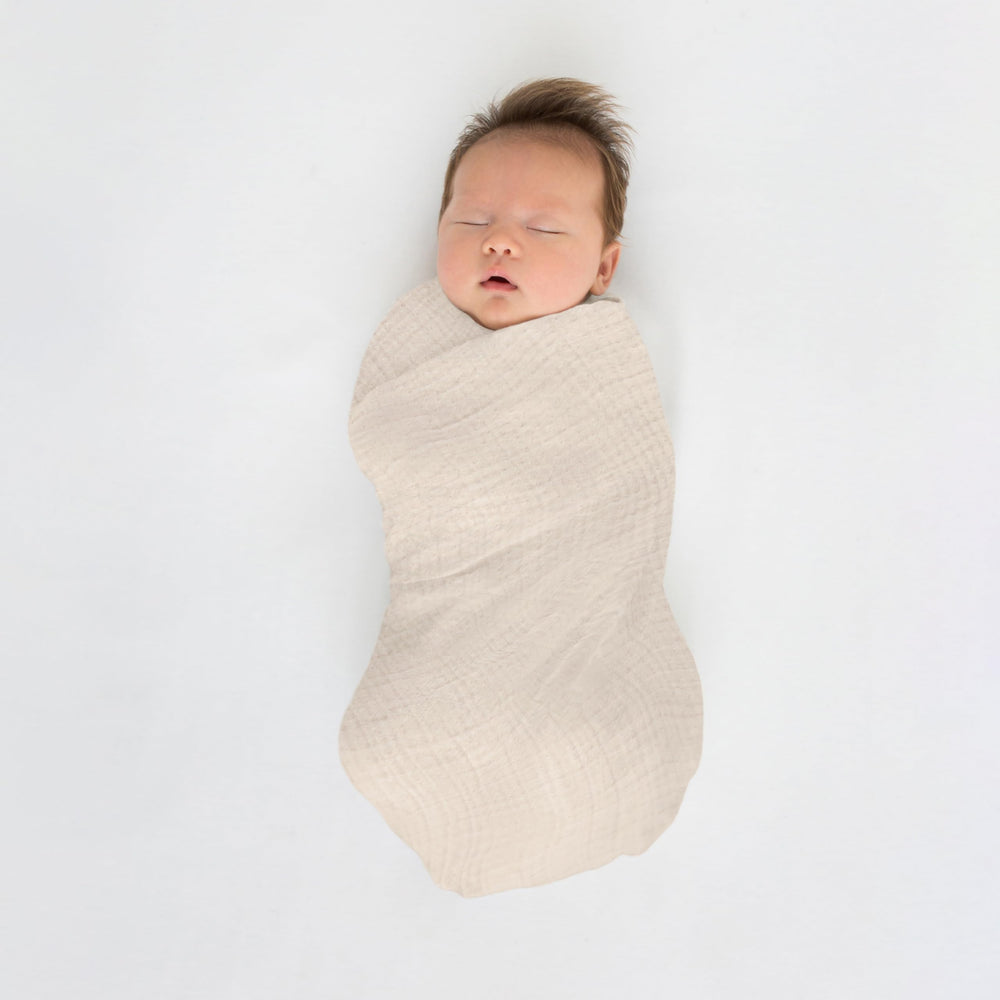 SwaddleDesigns Oceana muslin swaddle blanket as privacy throw during feeds.