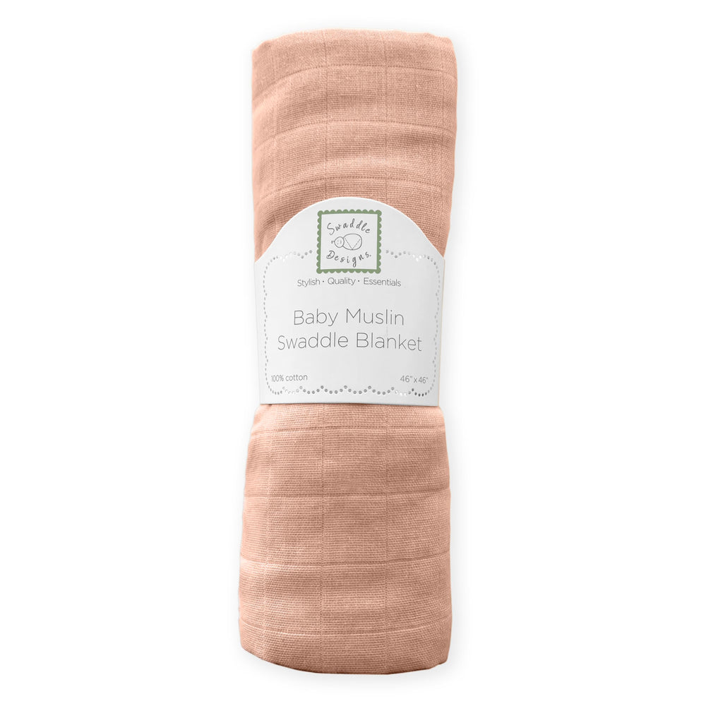 SwaddleDesigns Peach Blush blanket wrapped around a baby for secure swaddling