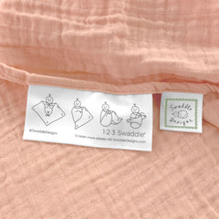 SwaddleDesigns Peach Blush blanket edge label shows easy swaddle steps