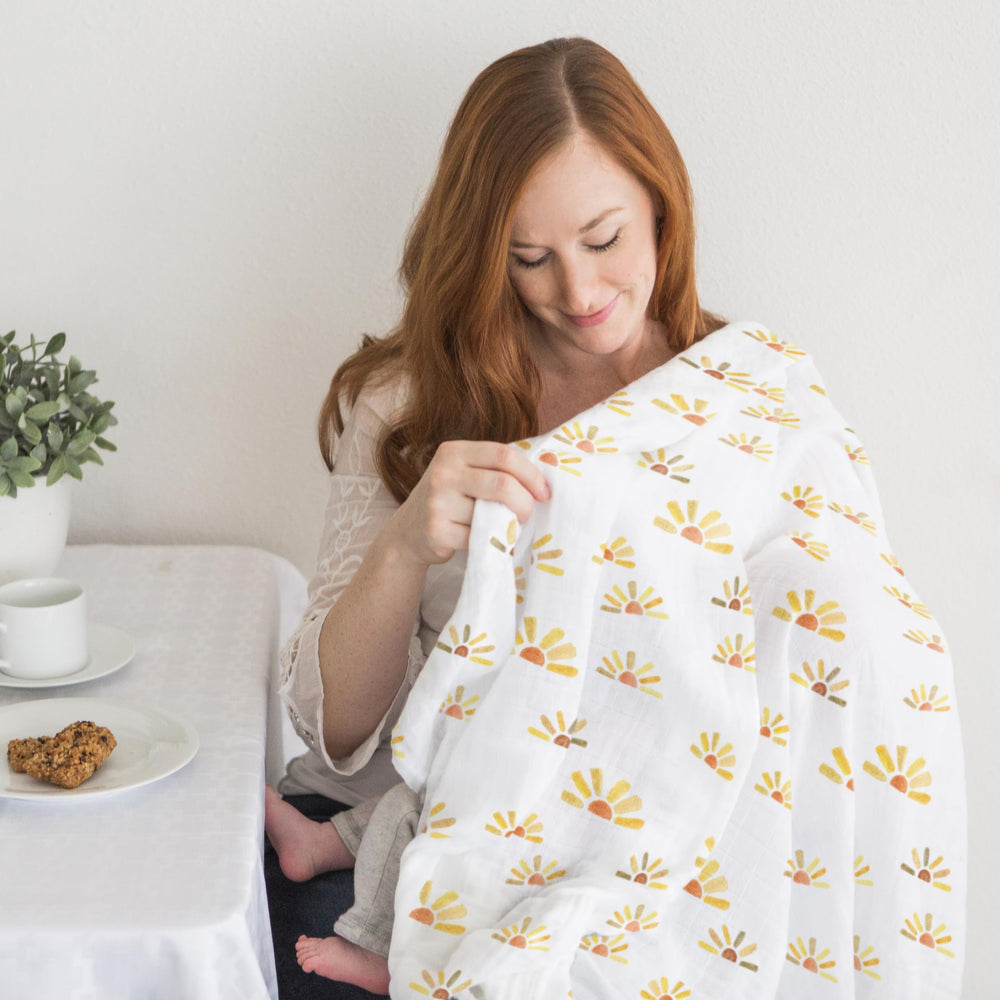 SwaddleDesigns watercolor sunny days stroller use demonstrates sunshield-like coverage