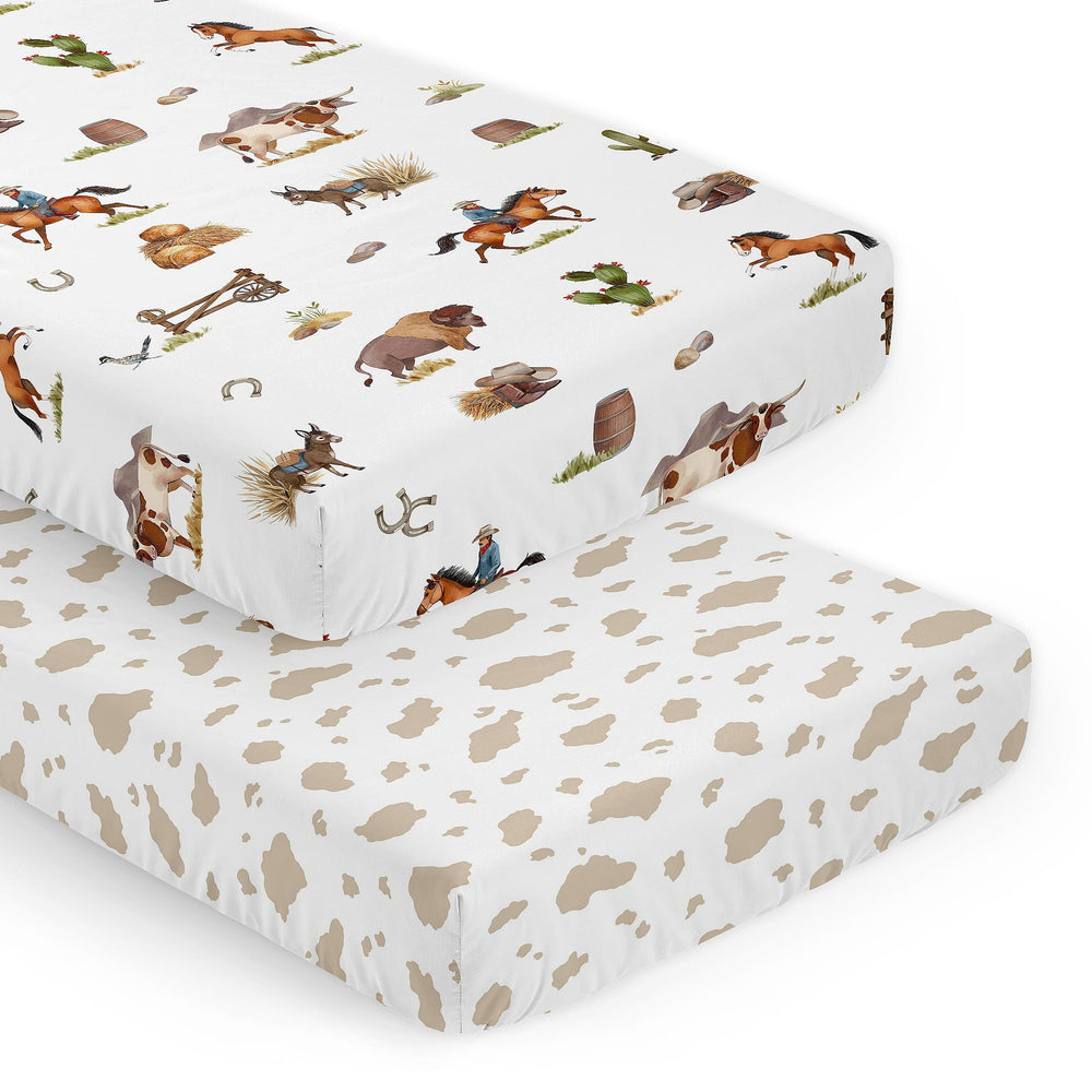Sweet Jojo Designs cow-print crib sheet front view shows snug, secure fit.