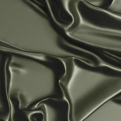Sweet Jojo Designs dark green satin fitted crib sheet on mattress with secure elastic edge.